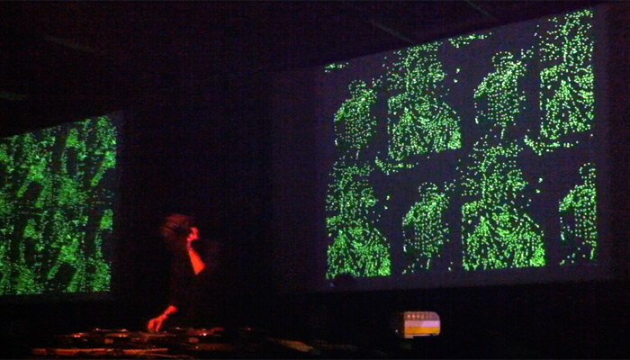a DJ with green dots in the background